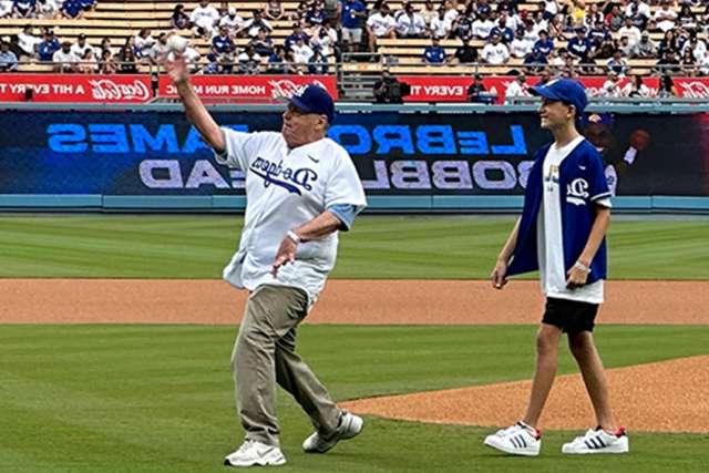 Dr. John Glaspy, accompanied by his grandson Braden, threw out the ceremonial first pitch at a recent Dodgers game. (Photo by Catherine Boyer)