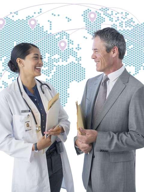 A businessman and doctor in front of a world map graphic.