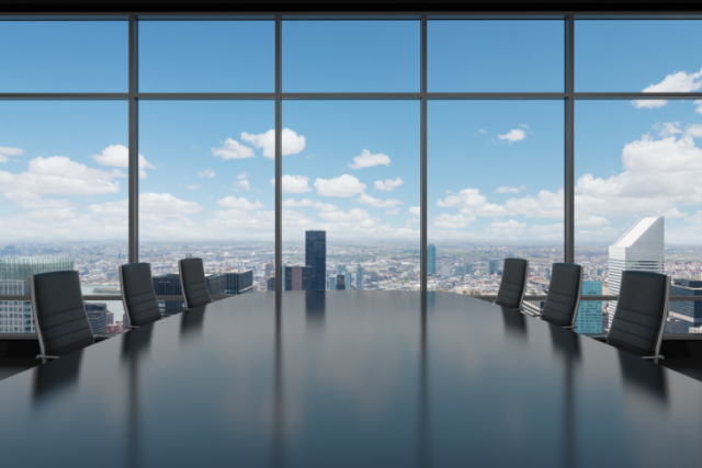 image of empty conference room with view of blue skies